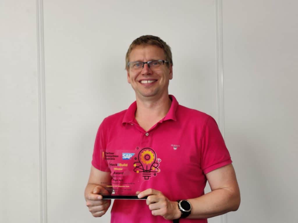 Founder and CEO Daniel Graversen with the trophy for winning the 2021 SAP Hack2Build